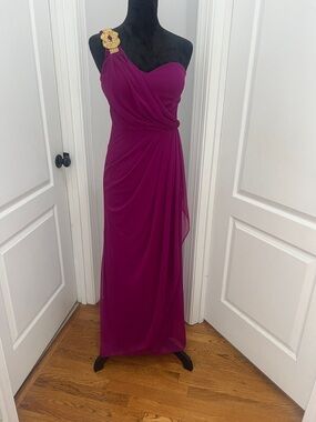 Xscape Elegant Evening Gown
Plum Color Size 8 Dress with Gold Embellishment.